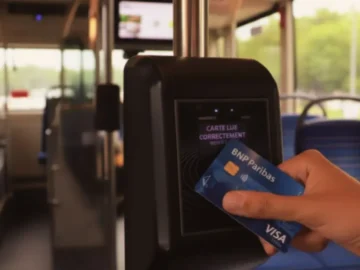 Voyageur utilisant une carte bancaire dans un bus parisien